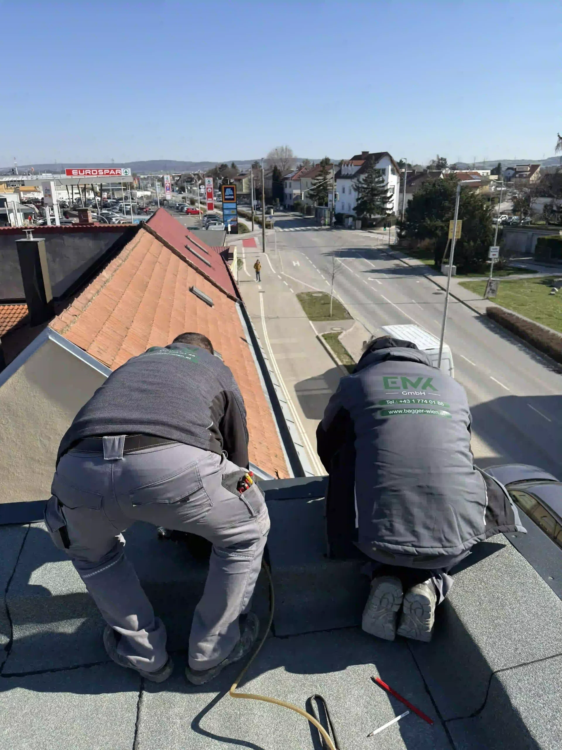 Bagger Wien – EMK Erdbau GmbH – Dacharbeiten Das Team der EMK Erdbau GmbH beim Abdecken eines Dachs